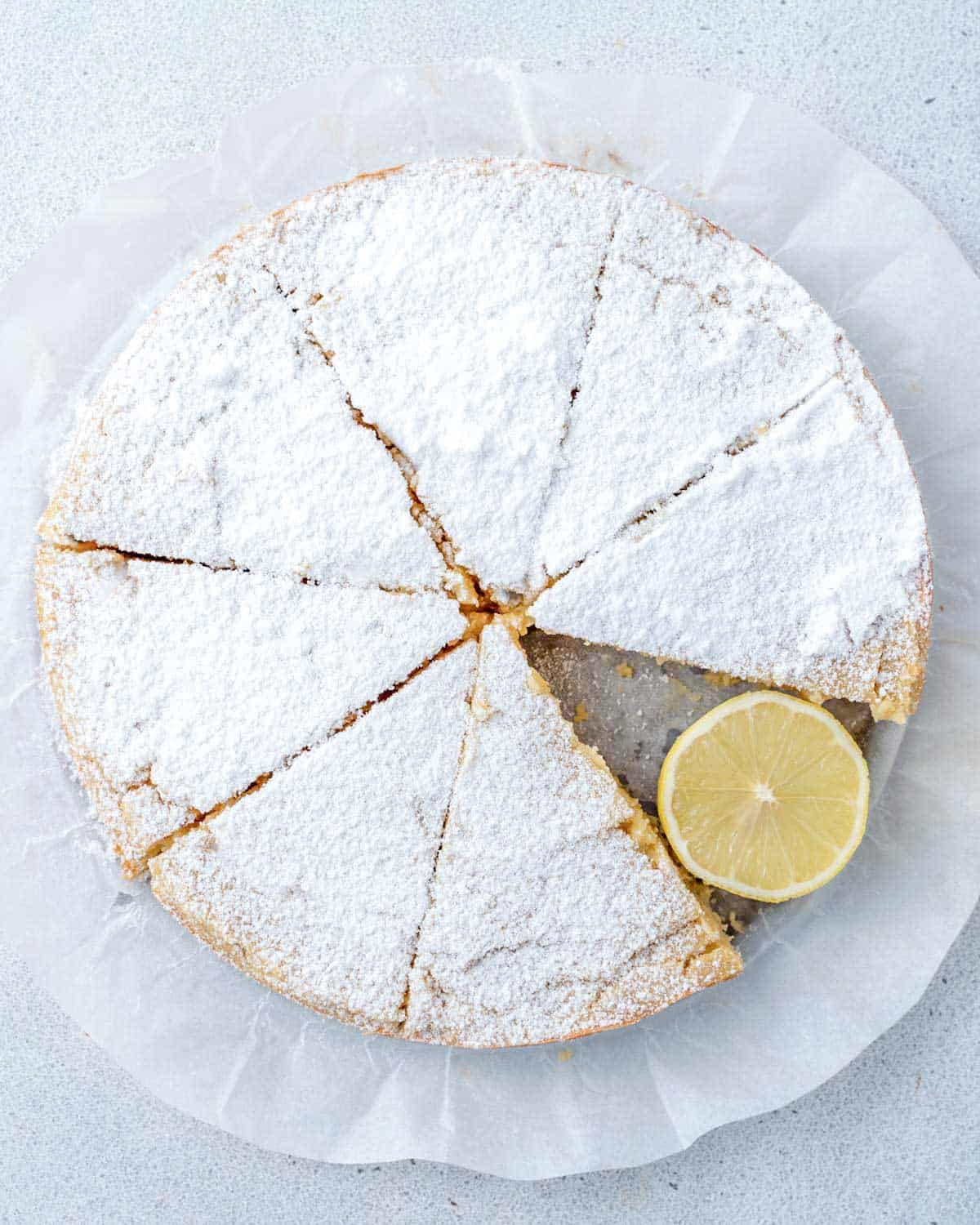 lemon olive oil cake sliced and topped with powdered sugar 