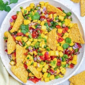a bowl with mango pico de gallo and a tortilla in the bowl.