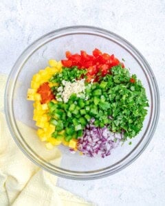 ingredients for mango pico de gallo added to a bowl