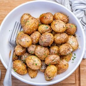 A round bowl with fried baby potatoes.