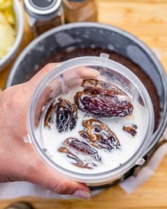 Adding the dates and milk into a blender.