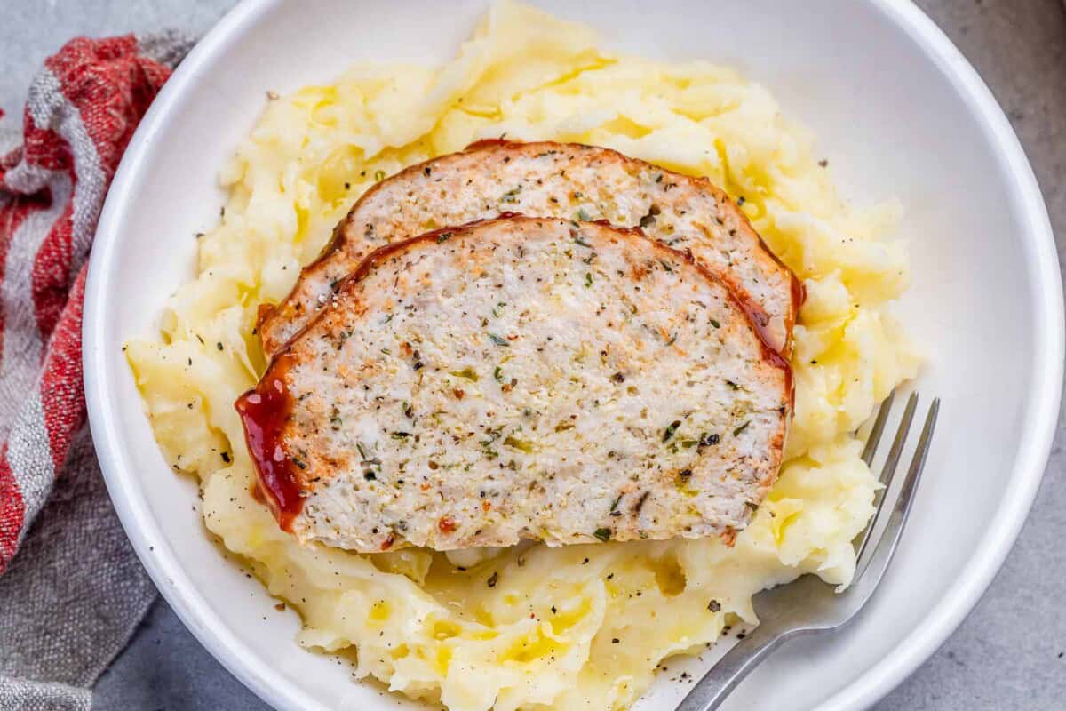 chicken meatloaf slices served over mashed potatoes.