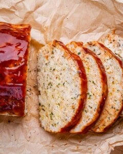 Meatloaf slices over parchment paper.