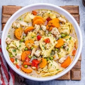 a round bowl filled chicken chicken and tortellini soup.