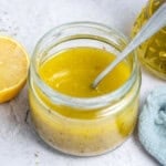 a small jar filled with Classic Mediterranean Salad Dressing thats yellow looking.