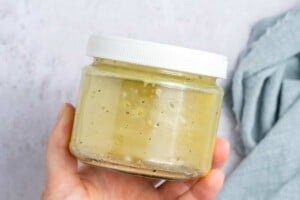 shaking salad dressing in a jar.