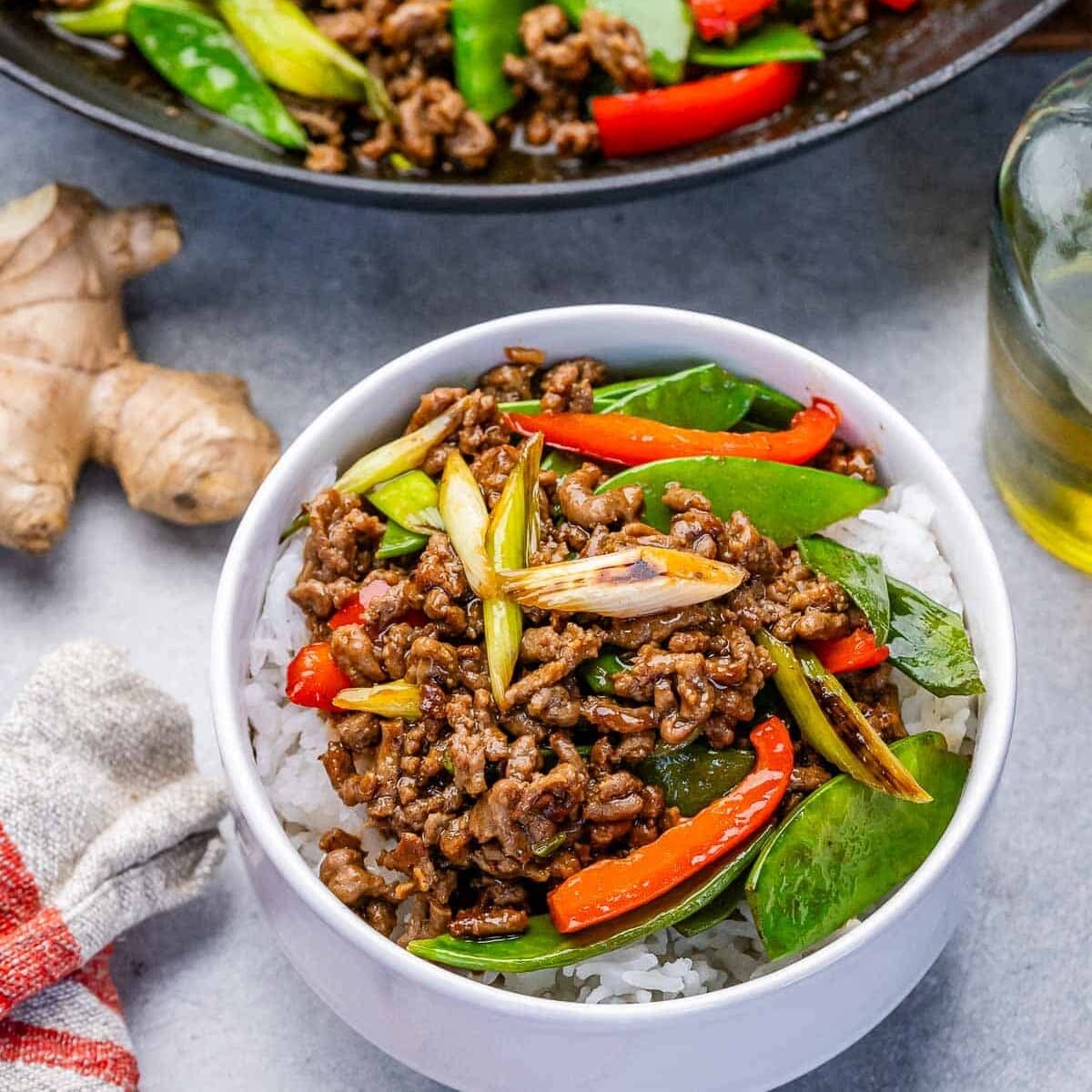 ground beef stir fry served over rice in a bowl.