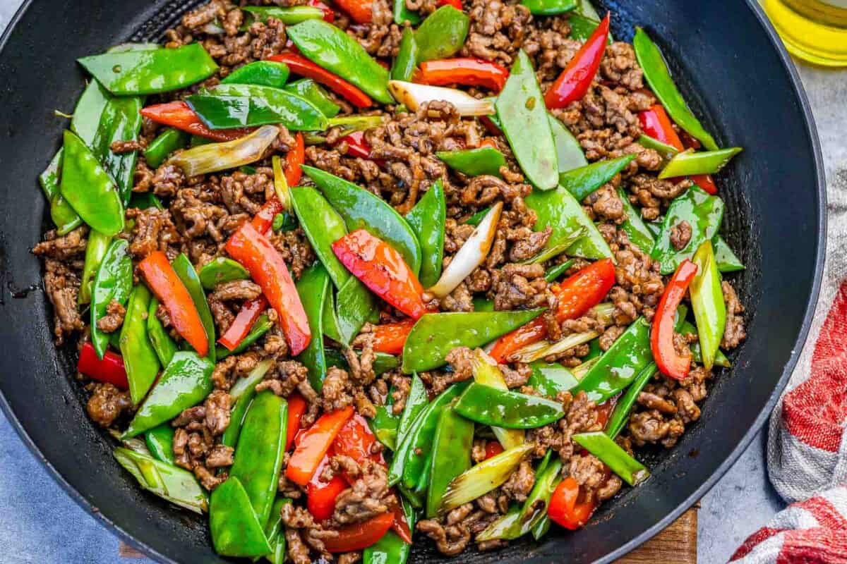 Beef stir fry with veggies in a pan.
