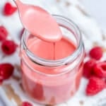 a jar filled with raspberry Vinaigrette dressing.