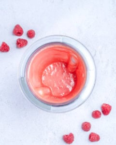 Blended raspberry dressing in a blender.