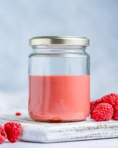 Raspberry vinaigrette placed in a lidded jar.