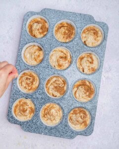 swirling the cinnamon sugar into the batter in muffin pan.