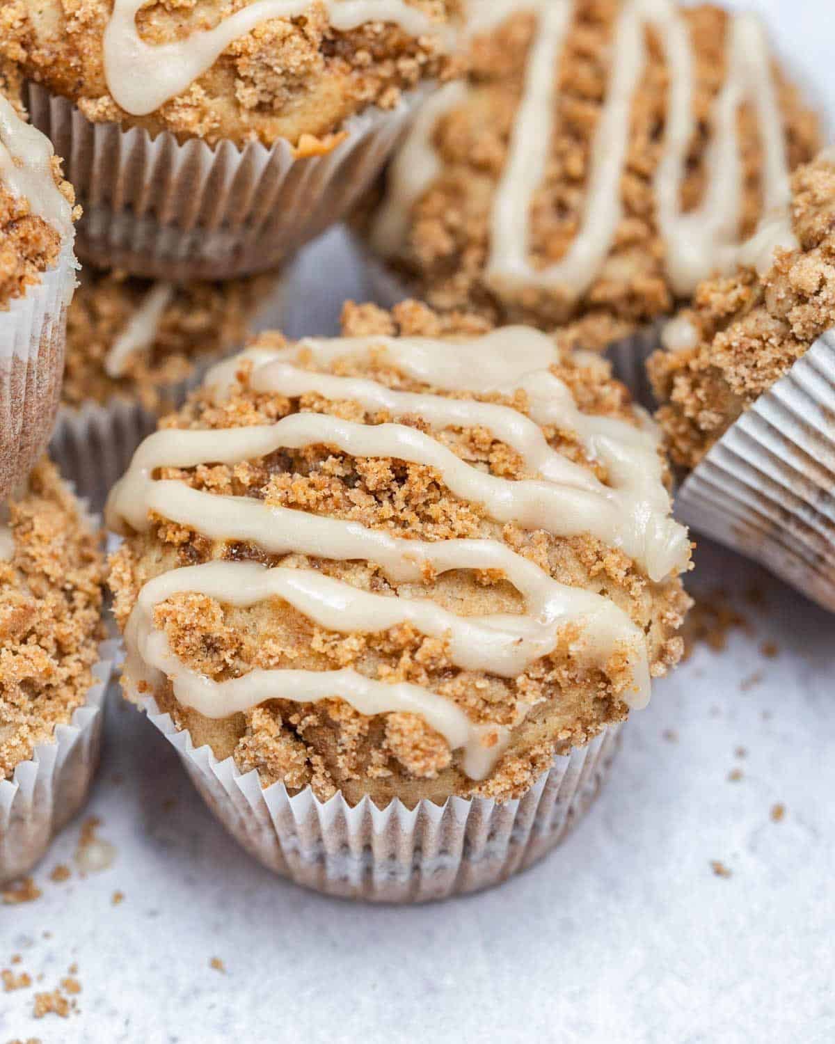 coffee cake muffins with a sugar glaze on a flat surface.