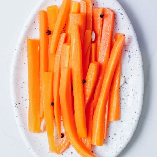 Pickled sliced carrots on a plate.