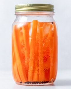 jar with pickled carrots and a lid.