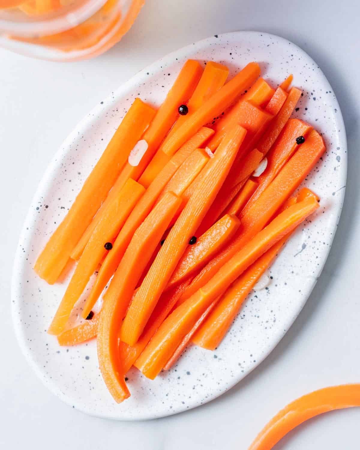 a plate with pickled carrot sticks.