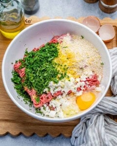 ingredients for greek meatballs placed in a bowl.