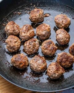 Meatballs cooked in a pan.