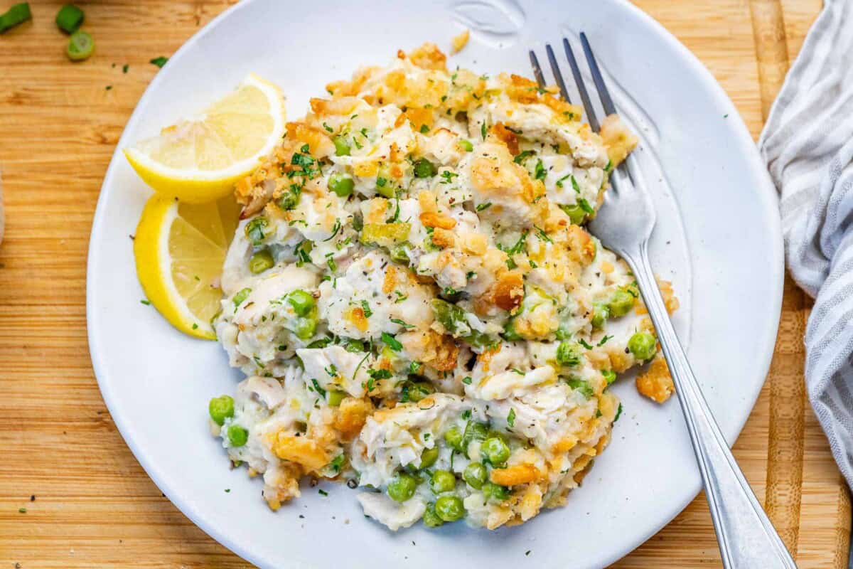 a serving of chicken casserole on a plate with a fork on the right side. 
