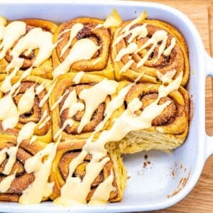 Pumpkin cinnamon rolls in a dish.