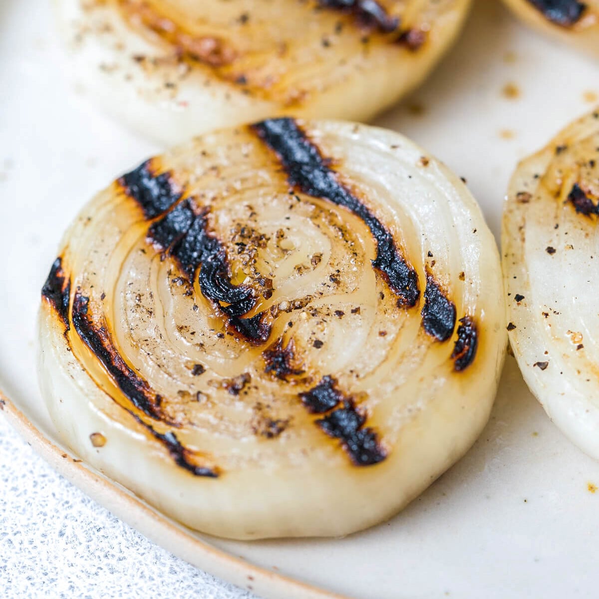 a sliced grilled onion on a plate.