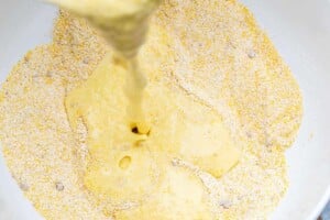 pouring egg and corn mixture over the dry corn and flour mixture.