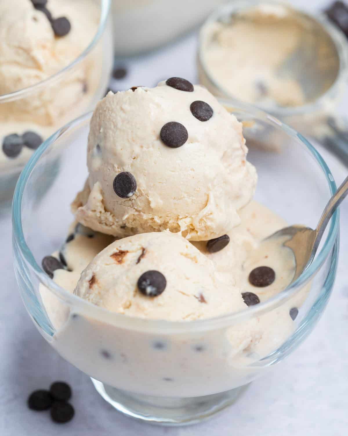 3 serving cottage cheese ice cream balls in a bowl topped with chocolate chips.