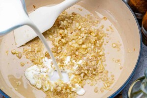 pouring cornstarch slurry over the sauteed onion and garlic.
