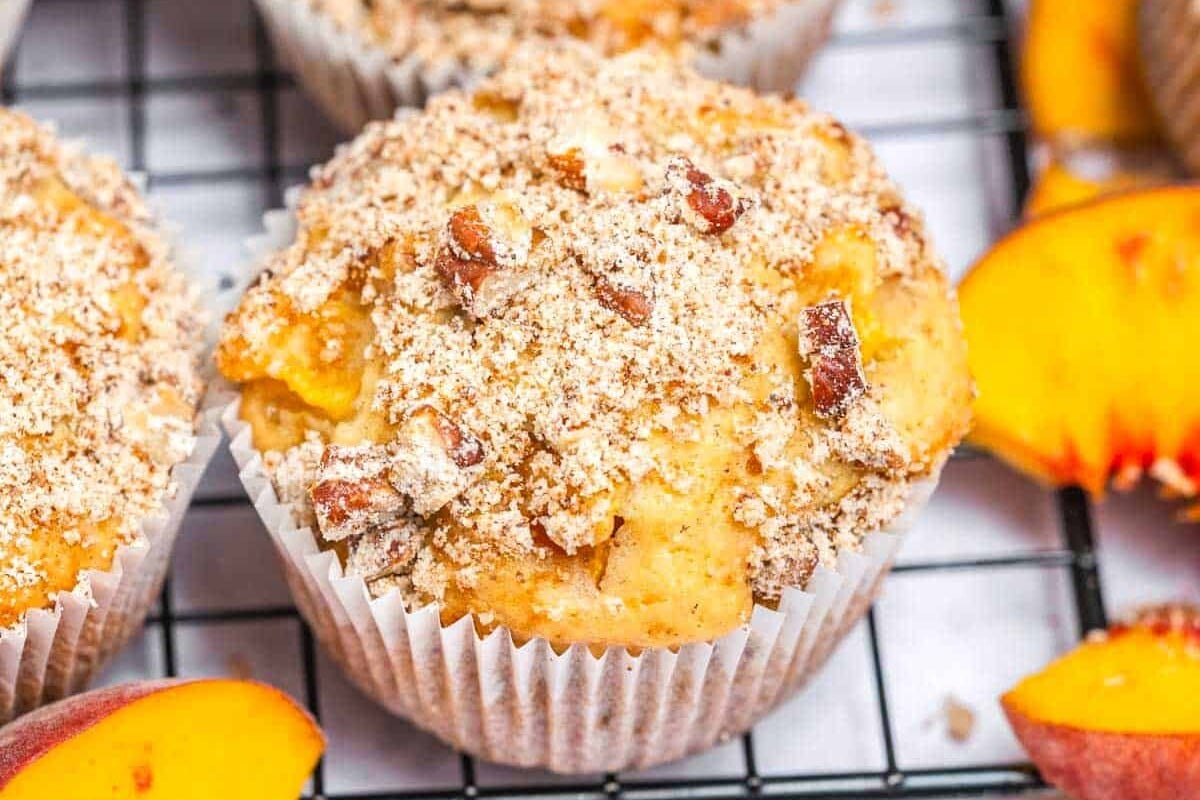 Peach muffins on a rack.
