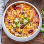 a round bowl with tortilla chicken soup made in the slow cooker.