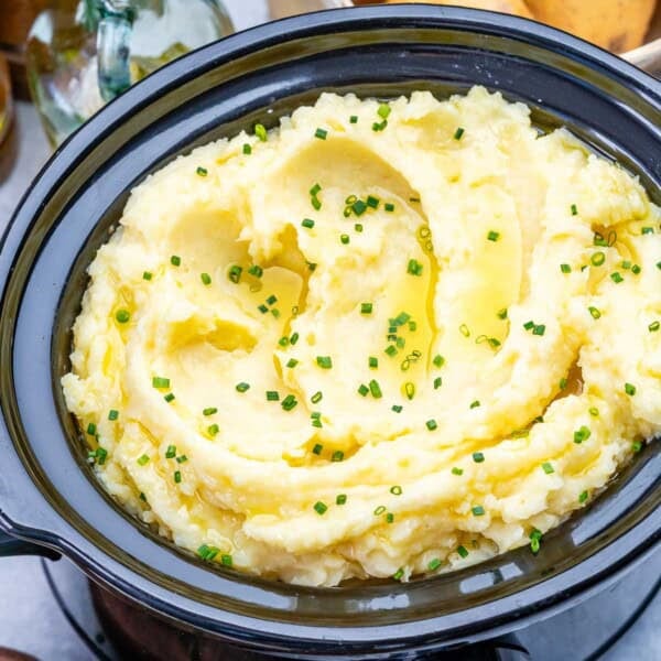 mashed potato made in the slow cooker topped with chopped chives.