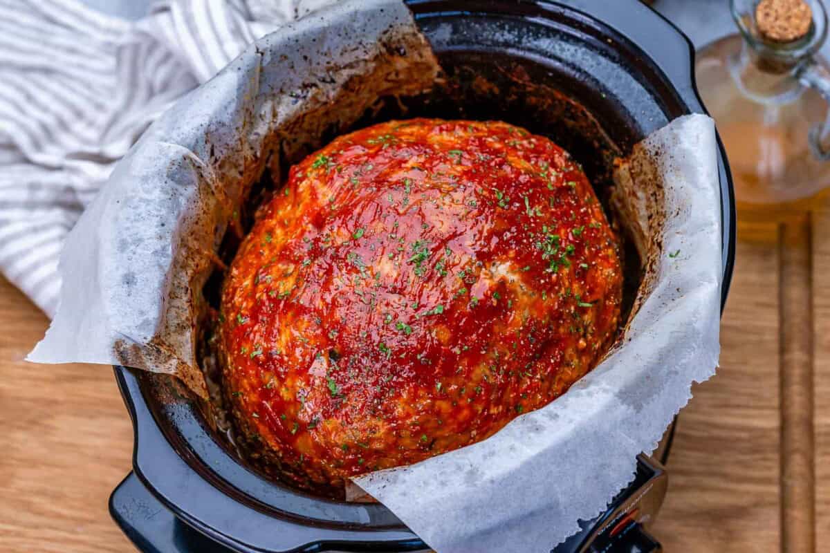 slow cooked meatloaf in a slow cooker whole and uncut.