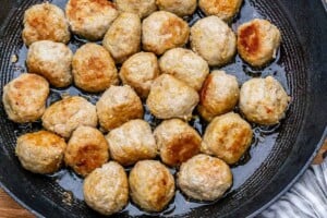 Meatballs cooked in a pan.