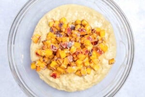 adding shopped peached in muffin batter.
