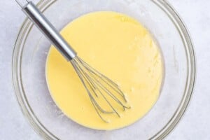 Mixing wet ingredients for muffins in a bowl.