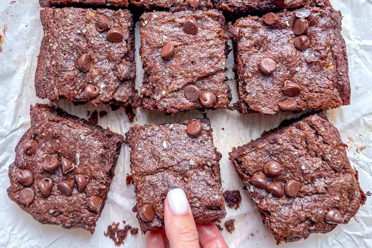 peanut butter brownie squares on parchment paper.