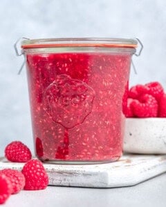 a jar container with raspberry jam.