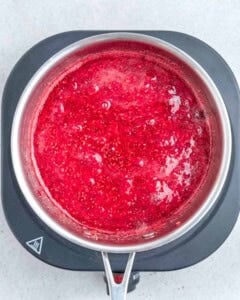 Cooked raspberries in a pan.