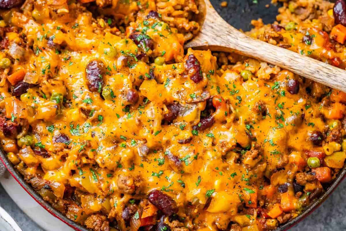 ground beef casserole in a skillet topped with melted cheese.