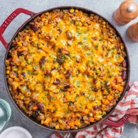 a round casserole pan filled with ground beef and rice casserole.