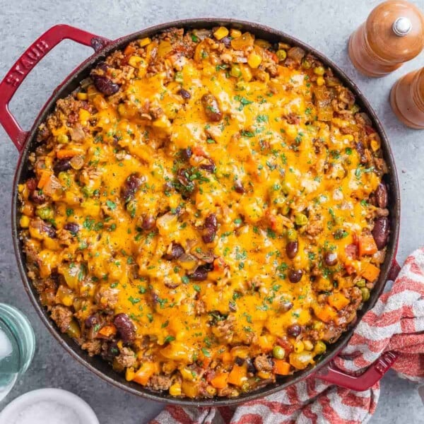 a round casserole pan filled with ground beef and rice casserole.