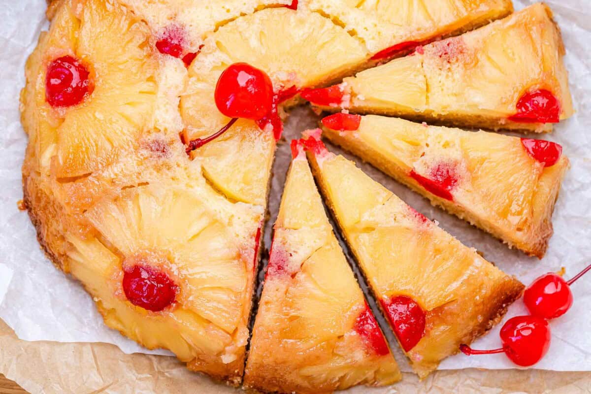 pineapple upside down cake sliced half way.