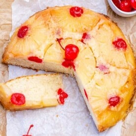 pineapple upside down cake with a few slices taken off the cake.