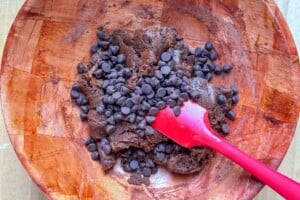 chocolate chips added to the dough in a bowl.