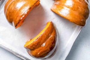 roasting pumpkin quarters on a sheet pan.