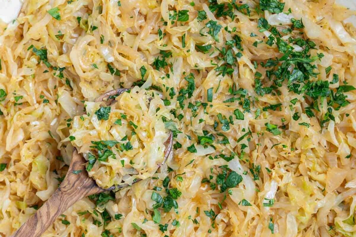 sauteed cabbage in a pan and then topped with chopped parsley.