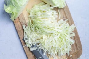 Sliced green cabbage on a cutting board.